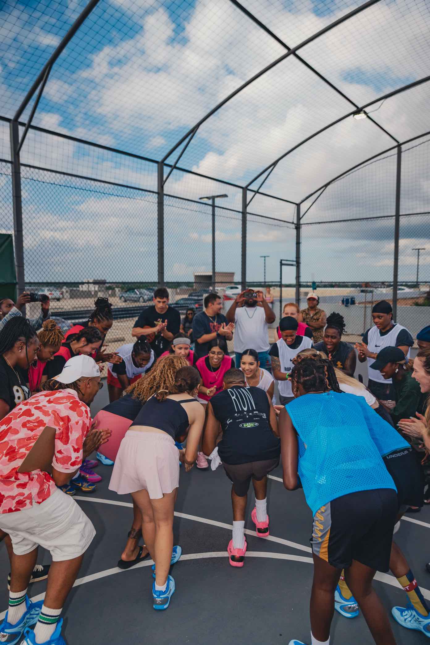 Players huddled together on a rooftop basketball court