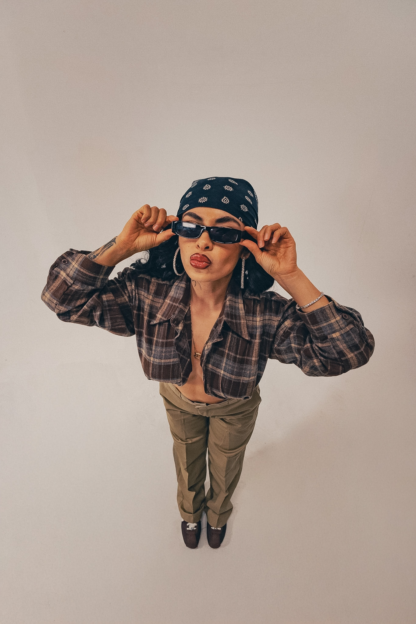 Studio portrait of a model in a bandana and plaid flannel