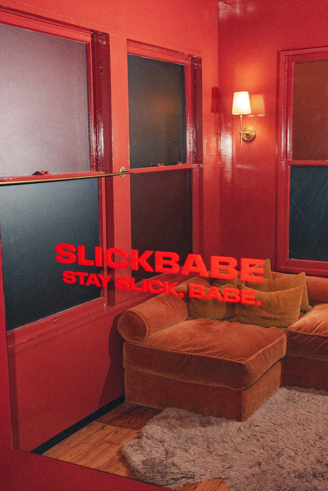 Red-lit interior with SLICKBABE branding
